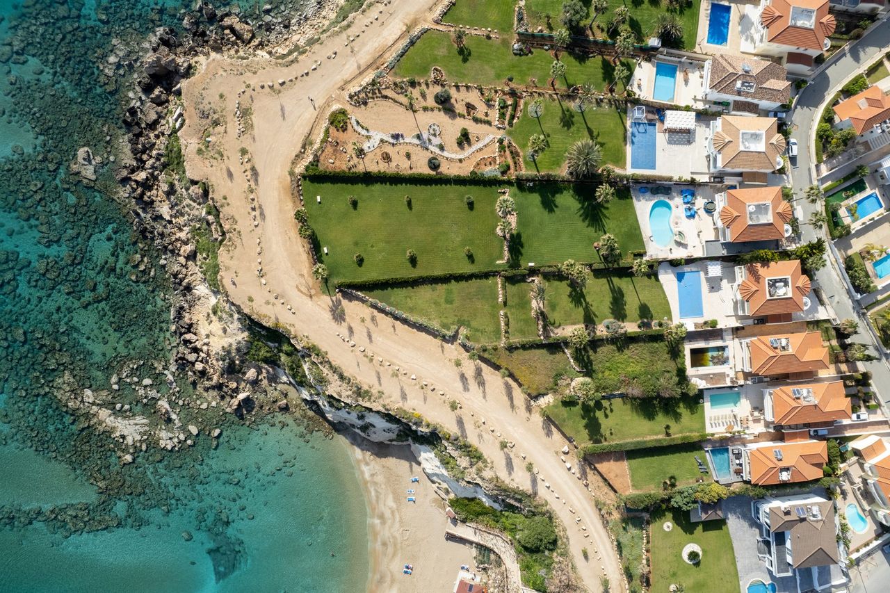 Aerial view of a master-planned development: streets, plots and finished houses laid out over the territory